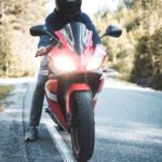 person riding red sports bike