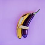 banana and eggplant on violet surface