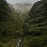 green mountain with river in the middle