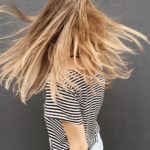 woman wearing black and white stripe blouse