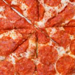 sliced pepperoni pizza in close up view